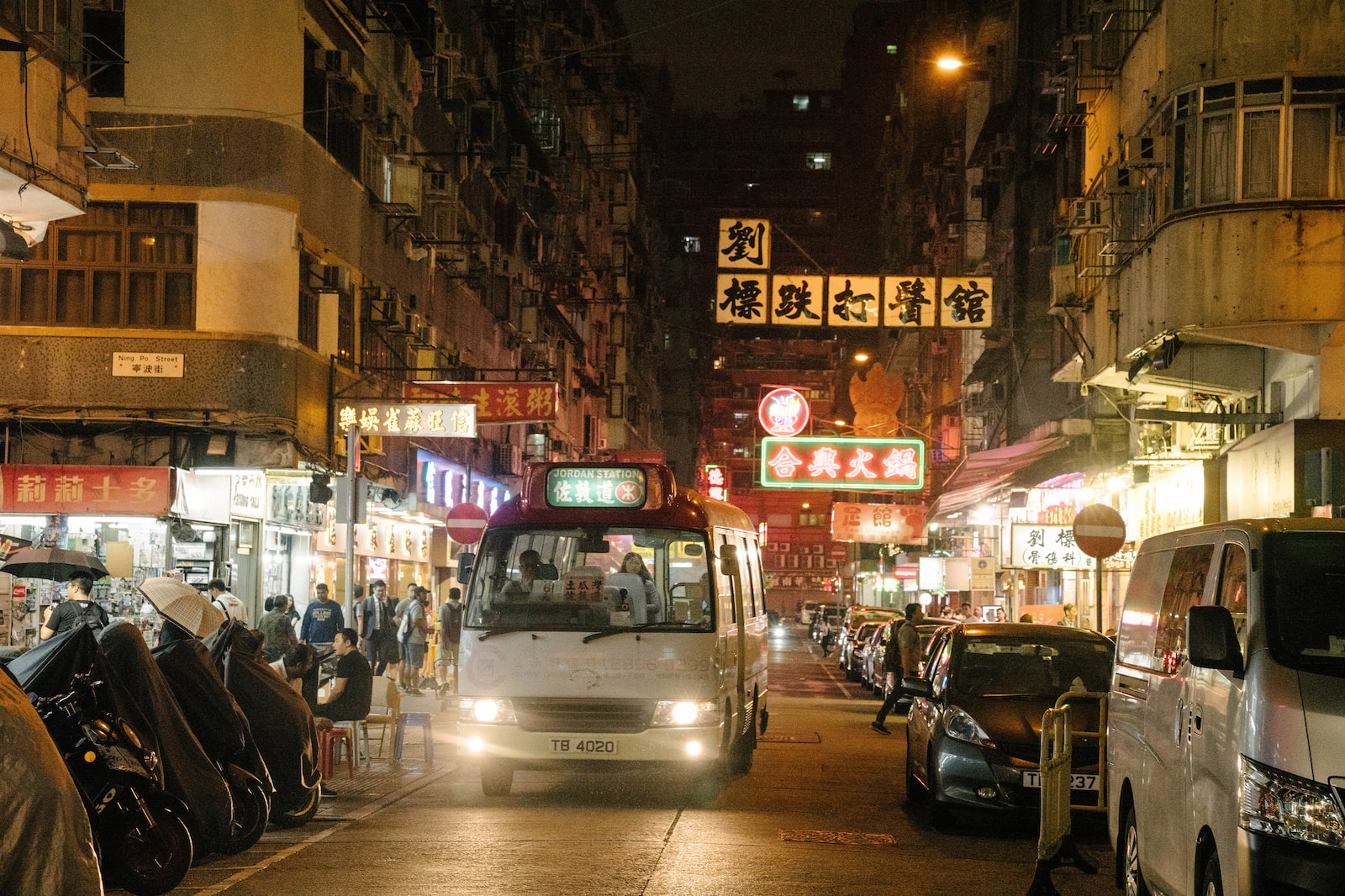 駛過廟街繁忙道路的白色車輛