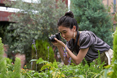 Female taking picture of plants 